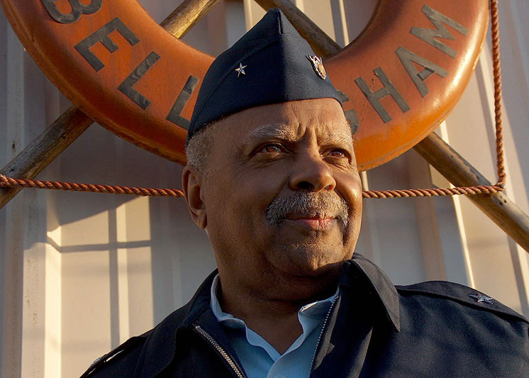 A coast guardsman smiling. Link to Life Stage Gift Planner Ages 45-65 Situations. 