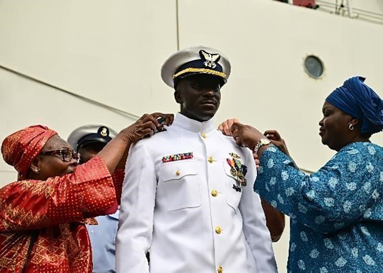 Two women helping a coast guardsman. Links to Gifts of Appreciated Securities
